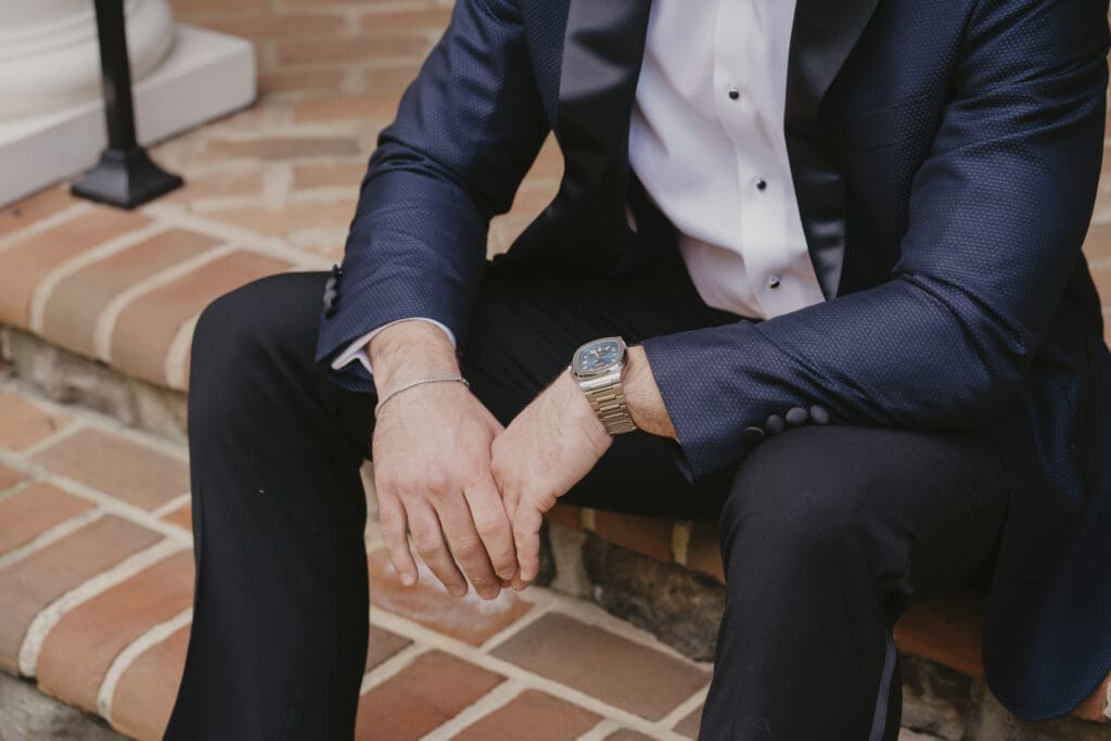 Groom sitting on stairs