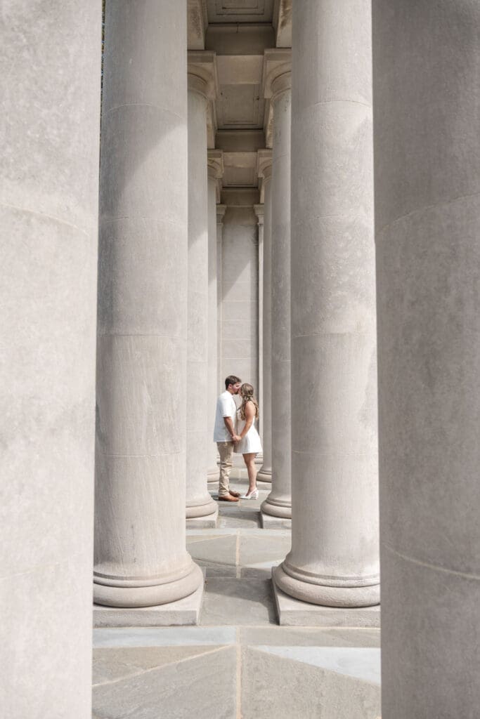 Engagement photo shoot between large pillars at Nemours Estate, Delaware
