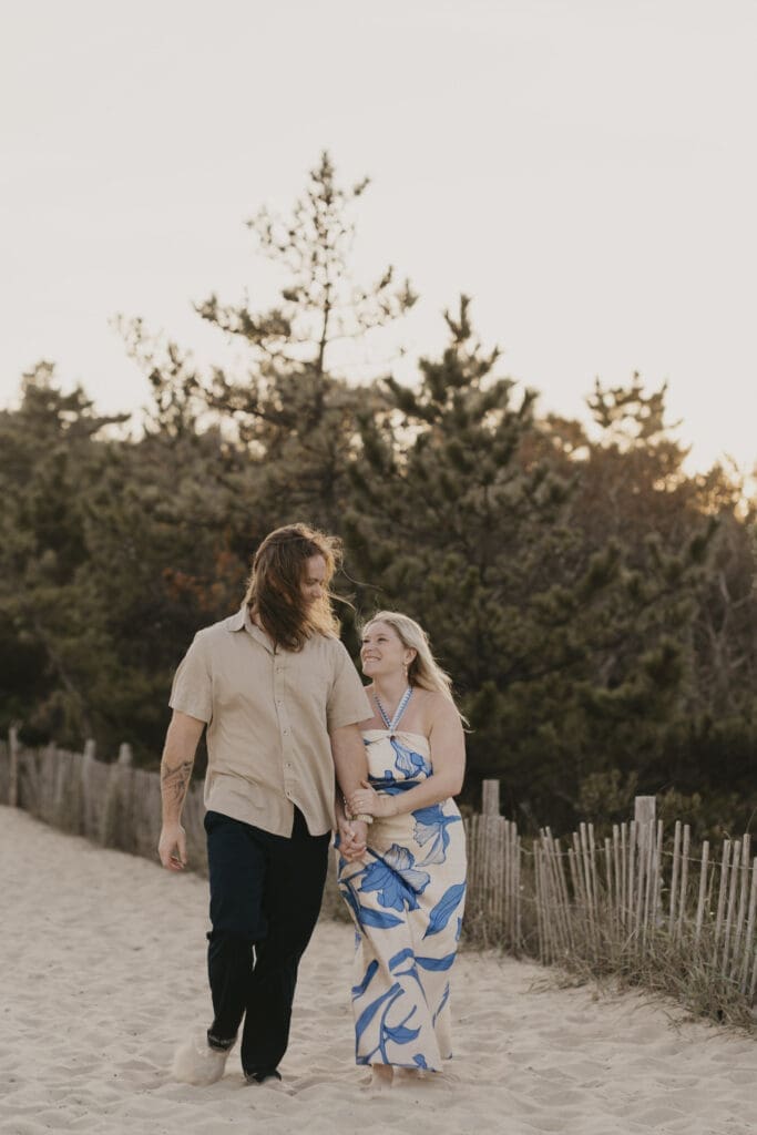 Couple walking on beach during their Cape Henlopen Beach photo shoot
